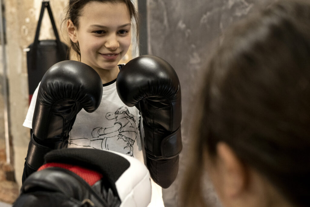 Muay Thai training for kids in Sidekick.
Color photography.